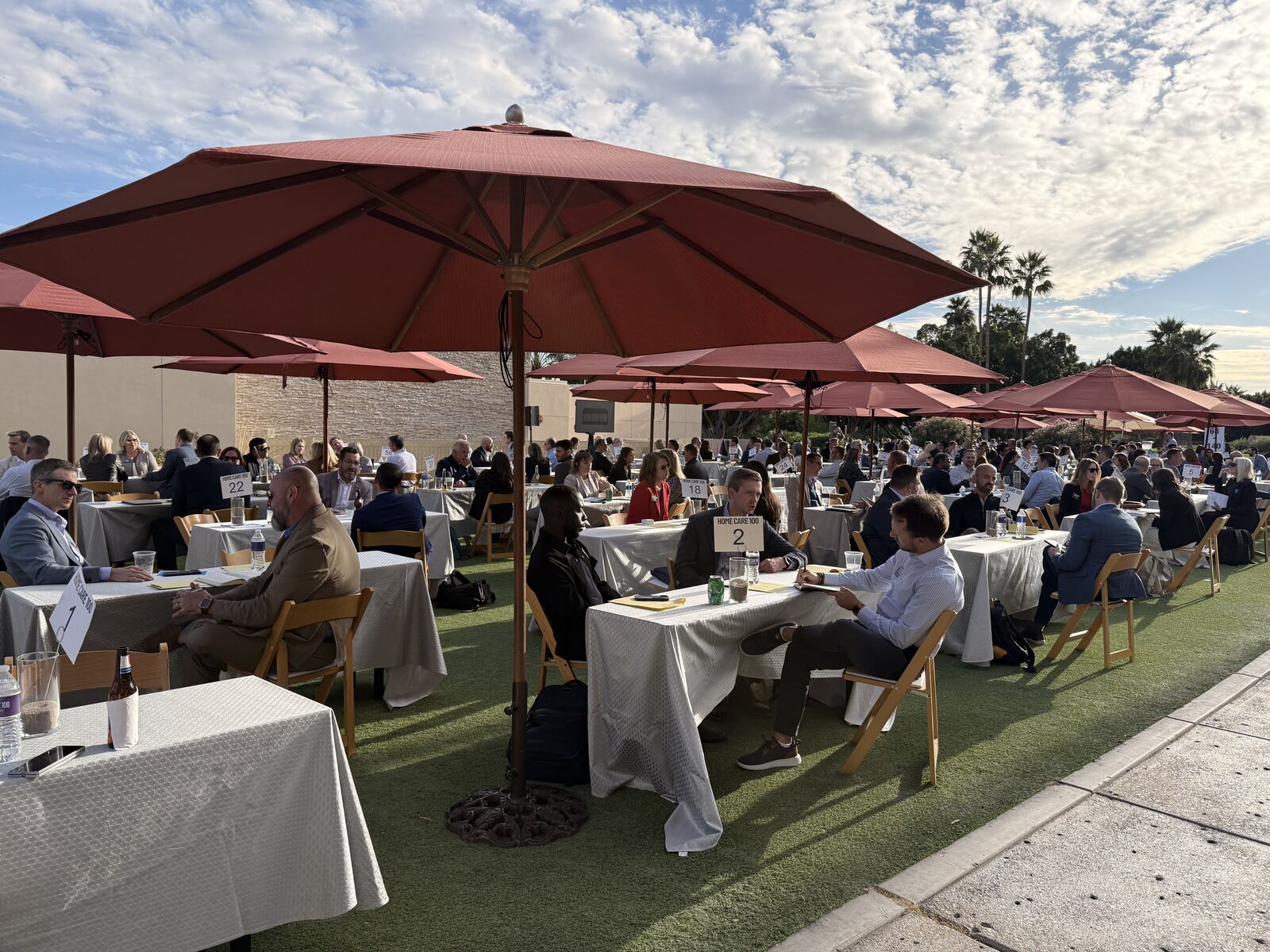 Speed meeting area with numbered tables under umbrellas